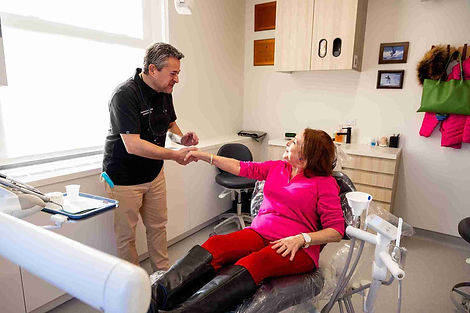 Madison Dental dentist discussing treatment with patient ensuring personalized dental care throughout appointment.