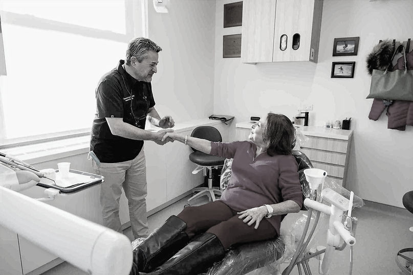 Madison Dental dentist discussing treatment with patient ensuring personalized dental care throughout appointment.