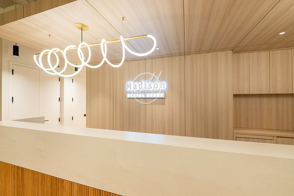 Madison Dental reception featuring illuminated logo creating welcoming atmosphere with stylish interior design for visiting patients.