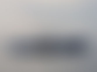 A blue and white lobster boat cruising through Belfast, Maine Harbor