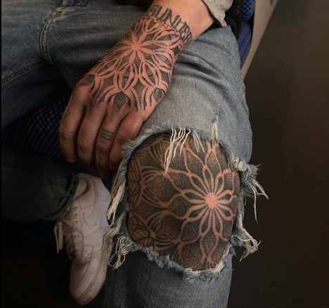 Hand und Knie mit Mandala-Tattoos