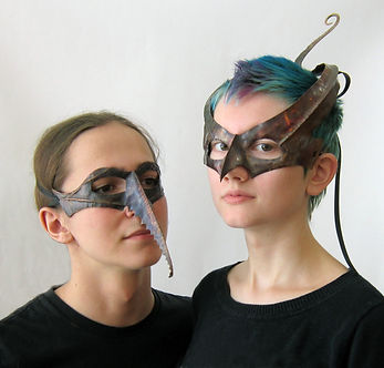delightful couple wearing handcrafted copper masks