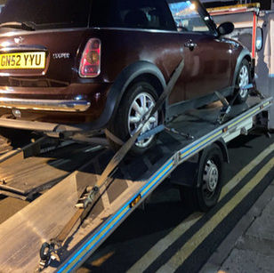 black car being recovered at night