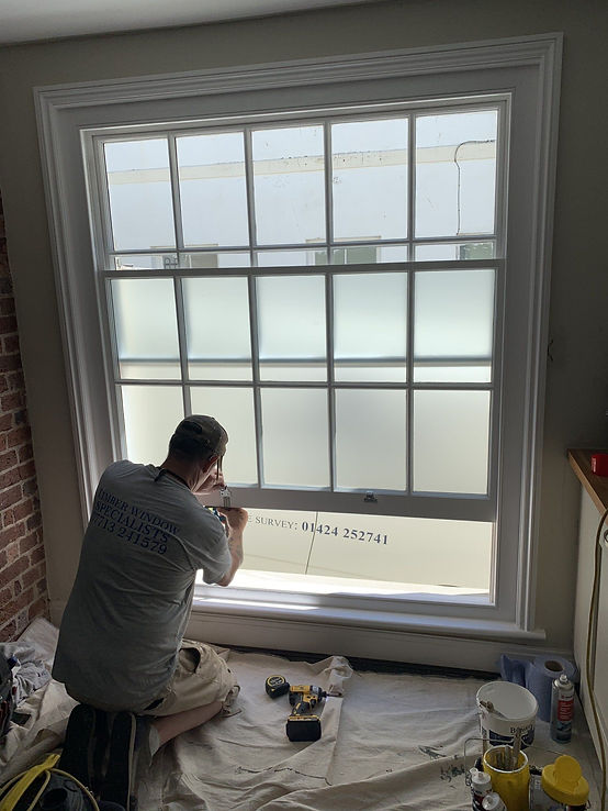 person painting a window