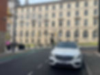 white car waiting to pick someone up