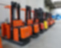 row of orange forklift trucks