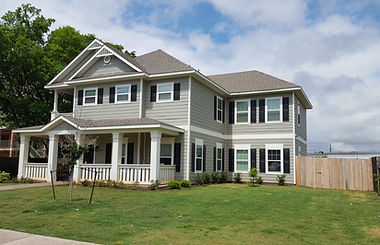 [Image Description:  Address:  1225 James Ave is an 8-bedroom, 8.5-bathroom home that is 2 stories and 4,455 Square Feet.  The exterior paint of this home is light grey with white and black trim.   Both the front door and balcony door are black.  This home is equipped with a washer and dryer.]