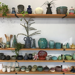 Finished pottery thrown on the wheel and handbuilt on shelves for sale at Throw Clay LA.
