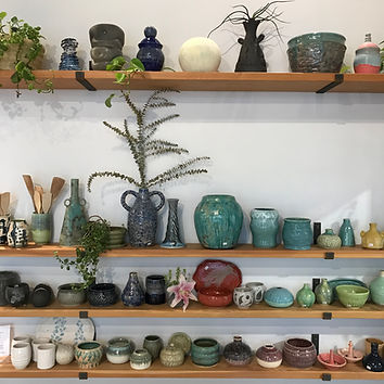 Finished pottery thrown on the wheel and handbuilt on shelves for sale at Throw Clay LA.