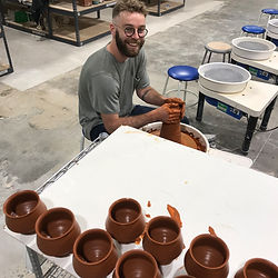 Danny, the instructor, throwing wine cups with consistency.