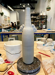 A tall bottle vase handbuilt.