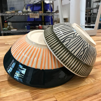 Finished ceramic platter with carved and painted surface patterns displayed in the pottery studio.