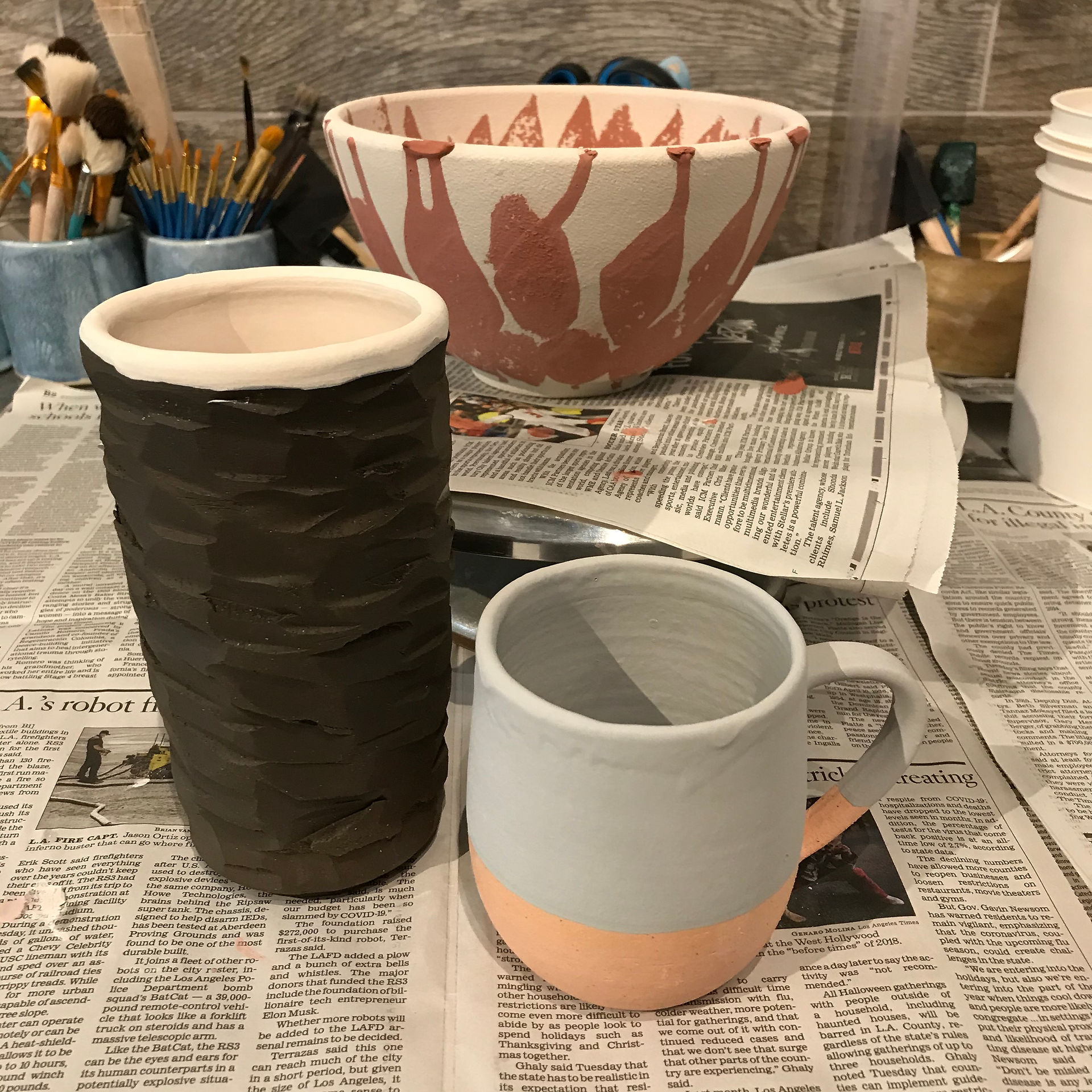 Glazed pots ready for the second firing in the kiln.