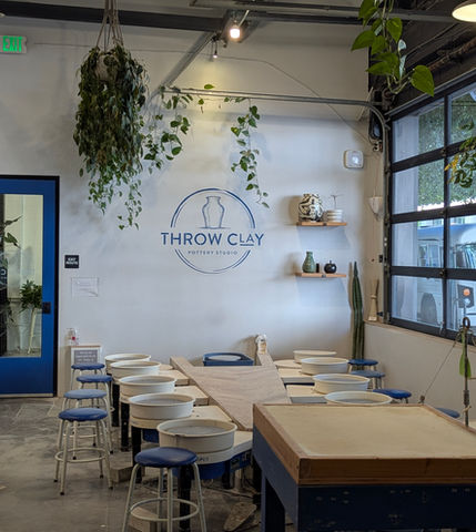 Interior of Throw Clay LA pottery studio with wheels and worktables