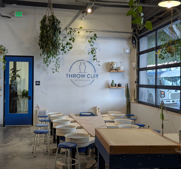 Interior of Throw Clay LA pottery studio with wheels and worktables