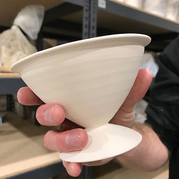 A wine cup out of the bisque kiln ready to be glazed.