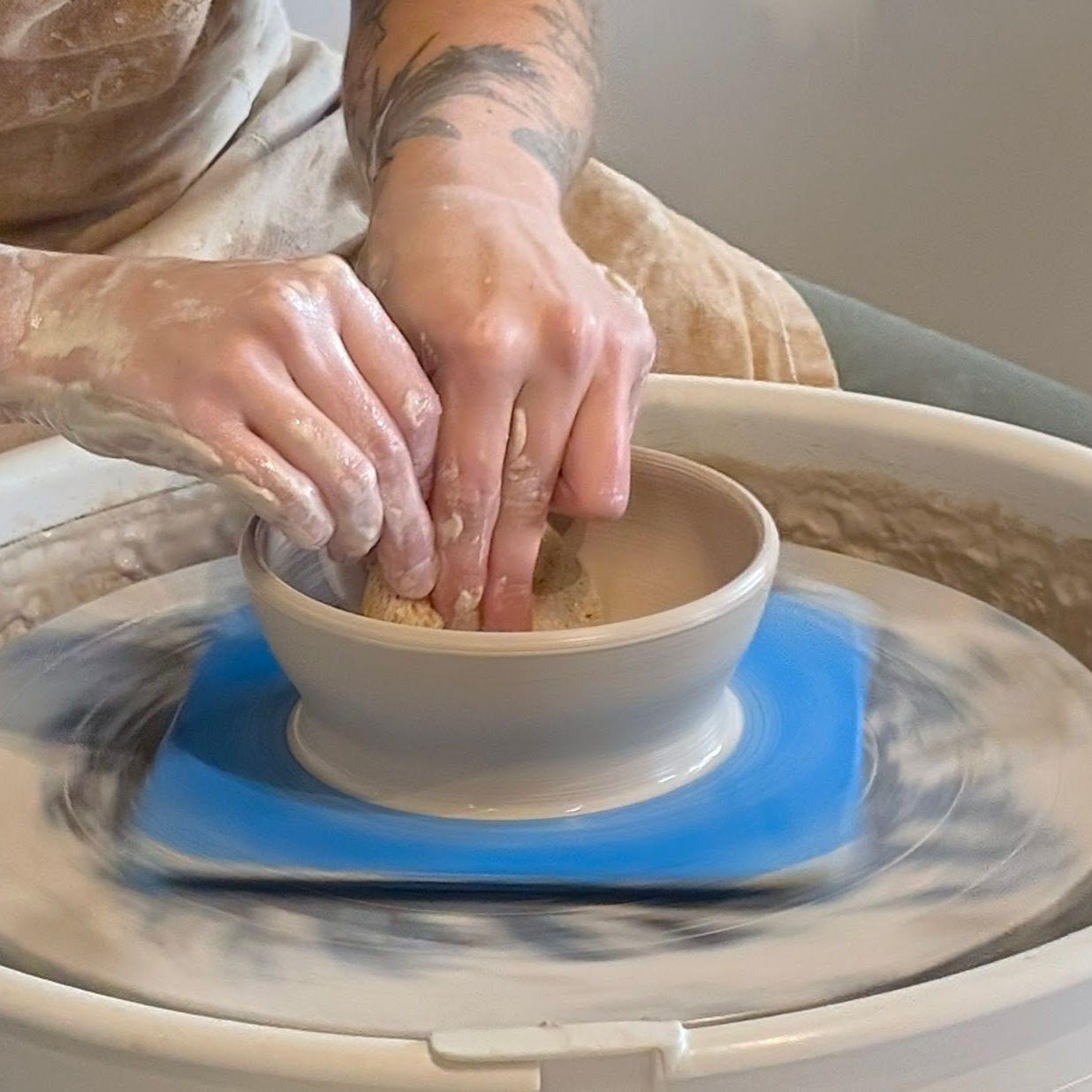Pulling up the sides of a cylinder on the potter's wheel.