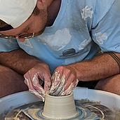 Pulling up the sides of a pot on the wheel.