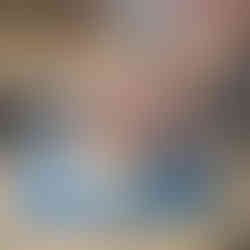 An intructor refining the walls of a wheel-thrown pot.