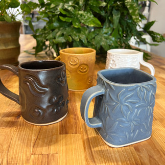 Handbuilt coffee mugs from a One-Time Big Mugs class.