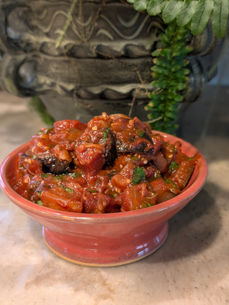 A Throw Clay LA bowl from a one-time class filled with Moroccan eggplant dip in bright red.