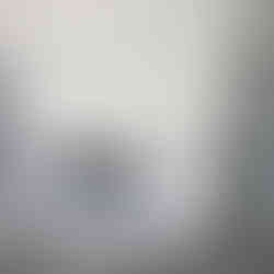 Minimalist room featuring a built-in electric fireplace, light gray walls, and luxury vinyl plank flooring.