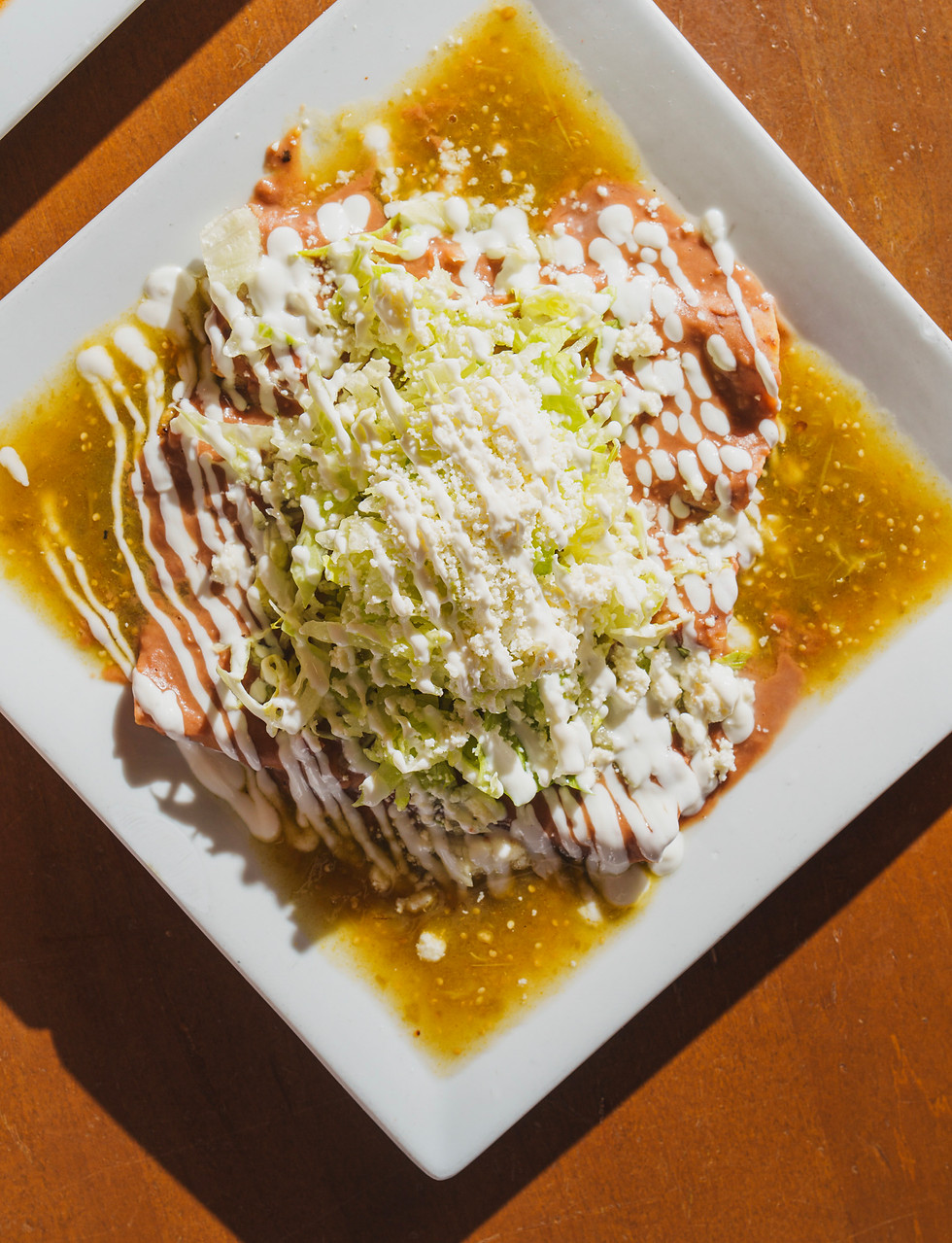 Homemade enchiladas with green salsa and crema
