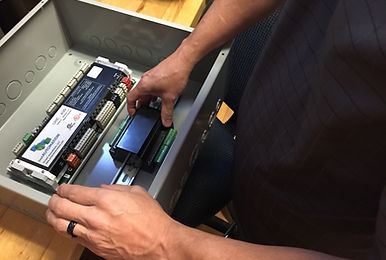 A technician puts together a security panel