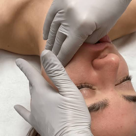 Registered Massage Therapist performing gentle intraoral TMJ massage to help relieve jaw pain and muscle tension.