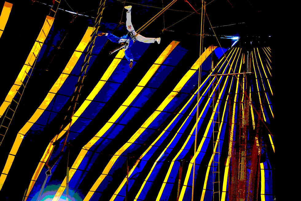 Photo taken at a performance by the Great Royal Circus in Kochi, India, on September 4, 2010. The outstretched arms and legs emphasize the idea of hands-free: the acrobat is holding on to the bar with his teeth!