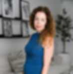 Lisa Alban Honored by KNOW Women, Tampa Chapter in 2025 stands in a chic living room, encircled by framed art and minimalist design elements.