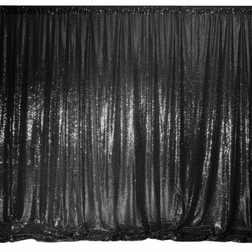 Black sequin curtain against a black background, creating a shimmering effect. Perfect for a glamorous event.