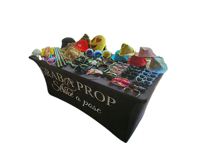 Event prop table with an assortment of playful accessories for guest photos and entertainment