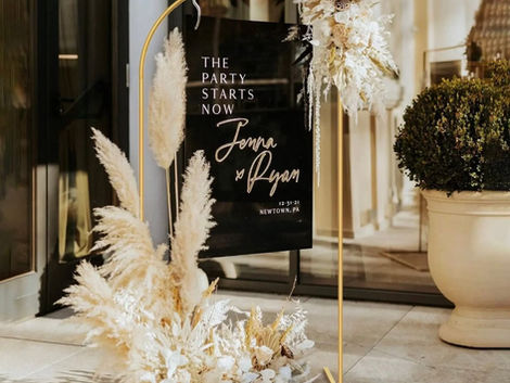 Gold arch backdrop set up as an elegant entrance for a party or corporate event.