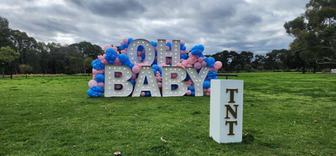 Gender reveal setup featuring OH BABY illuminated letters and balloon garland styling in Adelaide by Adelaide Starlight Entertainment