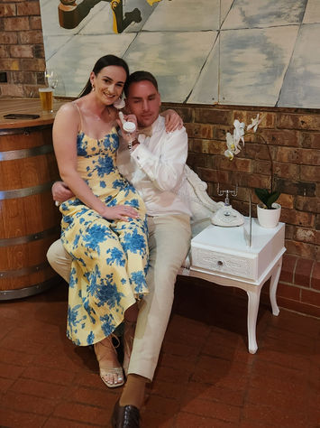 Wedding guest sitting at vintage white table using the Houston audio guestbook phone in Adelaide.