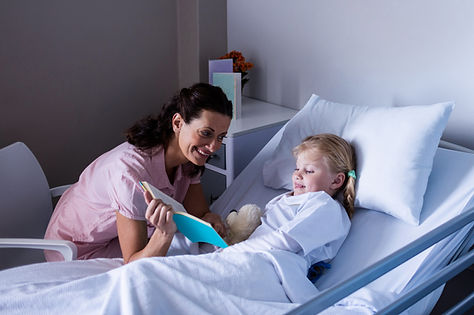 girl-on-a-hospital-bed-reading-book-with-her-mothe-2023-11-27-04-51-47-utc copy.jpg