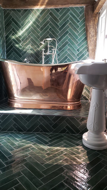 herringbone tiling & copper bathtub