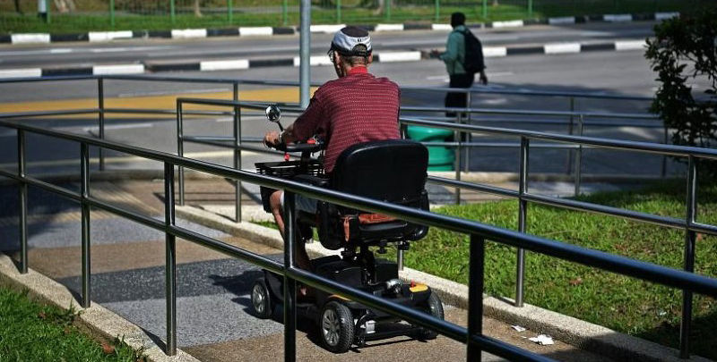 Man using a mobility scooter on a ramp