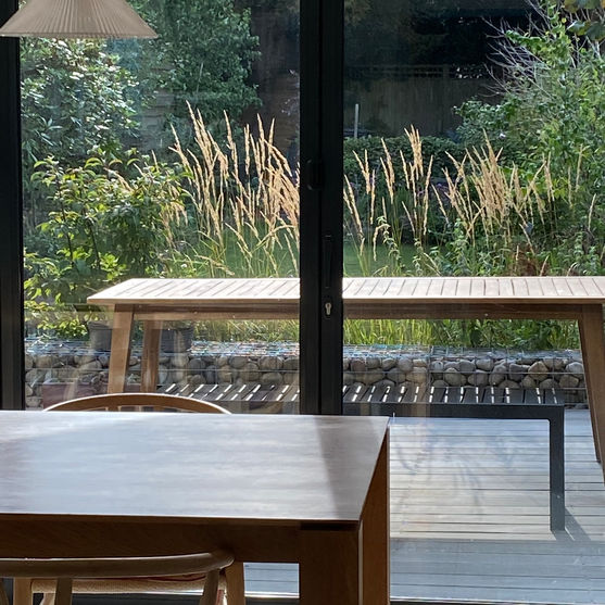 Contemporary living: decking through bi fold doors. Gabions.