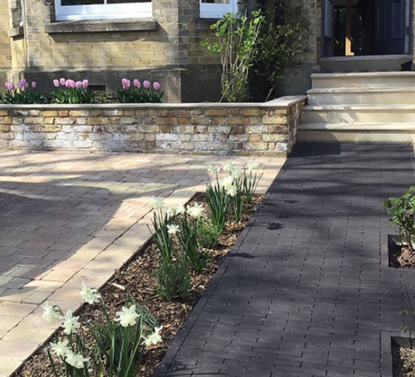 Traditional/ contemporary town drive with pavers and dutch brick path.