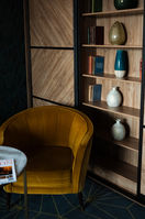 Interior corner with a yellow armchair and built-in shelving, property photography for a Dublin listing