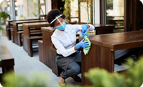 cafe-owner-cleaning-tables-with-disinfectant-while-reopening-covid19-pandemic.png