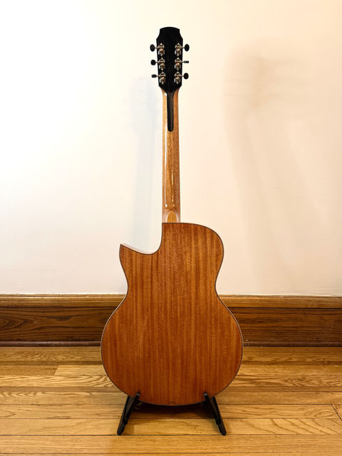 The rear of a Honduran Mahogany Cutaway with matching binding and thin purfling details.  An Ebony backstrap is veneered on the rear of the headstock.