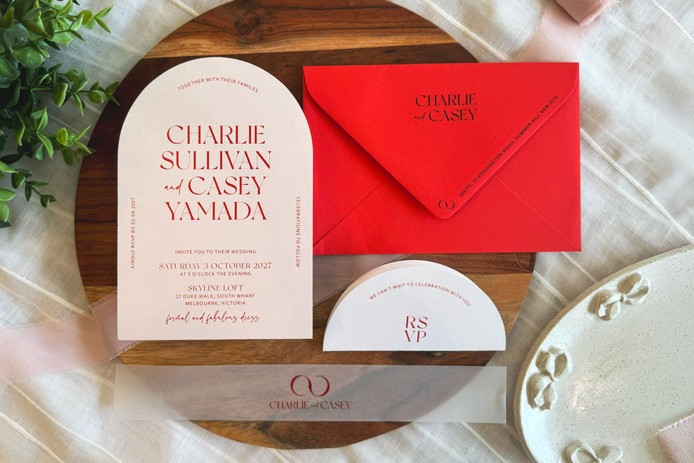 Blush arch wedding invitation with folded circular RSVP tag and vellum band