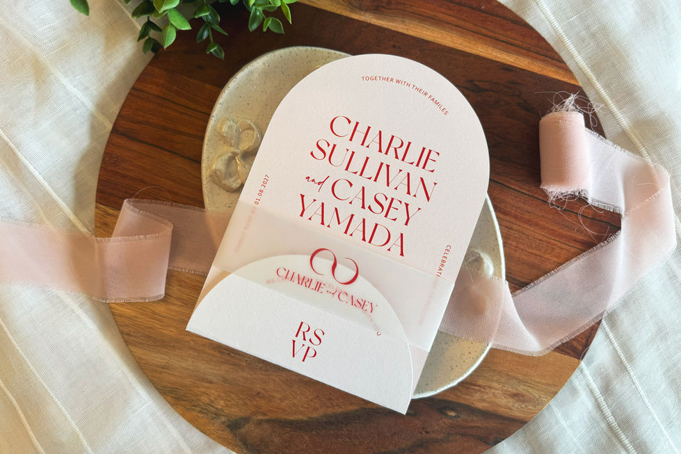 Contemporary wedding stationery set featuring blush arch card, circle tag, and vellum wrap