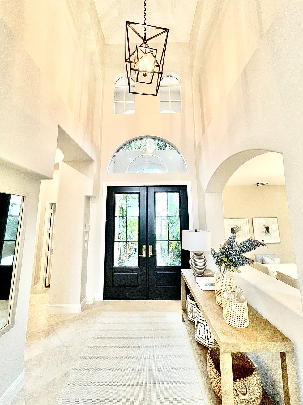 Luxury custom home entry Foyer in Jupiter with double entry doors, arches and high ceilings
