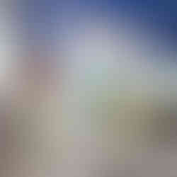 Farmer's Creekside Tavern and Inn Room: Blue wall with teal bedding and florals on a table