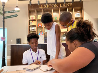 Teamwork in action at Planet Word's Lexicon Lane—where words become puzzles and curiosity leads the