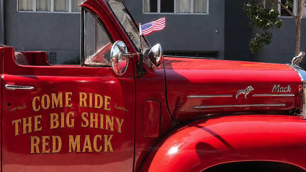 Vintage San Francisco Fire Engine with the words "Come Ride The Big Shiny Red Mack" painted in gold on the door
